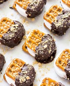 chocolate covered waffles with white frosting and peanut butter on top are sitting on a baking sheet