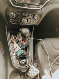 the interior of a car with various items on the dash board and steering wheel controls