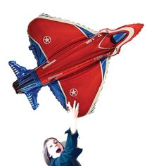 a woman flying through the air with a red and blue kite in front of her