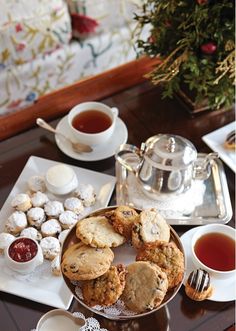 tea and cookies on a table with silverware