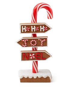 a wooden sign with candy canes on top of it