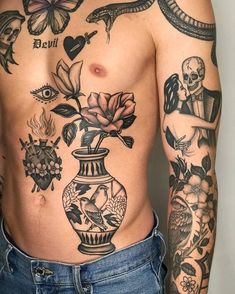 a man with tattoos on his stomach has a vase full of flowers and birds in it