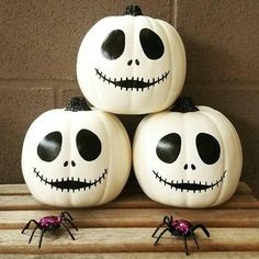 three pumpkins with faces painted on them