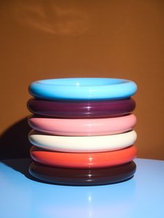 a stack of colorful plates sitting on top of a table