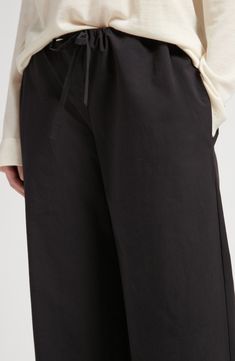 The label's focus on exceptional fabrics and clean lines shines through the premium cotton design of straight-leg pants cut to a contemporary cropped length. A drawstring waistband offers a personalized fit with every wear. 22" inseam; 15 1/2" leg opening; 11" front rise; 14" back rise (size Medium) Drawstring waist Side-seam pockets 100% cotton Dry clean Made in Italy Designer Clothing Modern Relaxed Fit Wide Leg Pants With Elastic Waistband, Cotton Pants With Elastic Side Panels For Work, Cotton Work Pants With Elastic Side Panels, Cotton Ankle-length Pants With Elastic Side Panels, Black Cotton Wide Leg Pants With Drawstring, Modern Bottoms With Elastic Waistband, Modern Cotton Pants With Elastic Waistband, Hairstyling Products, Rollerball Perfume