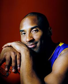 a basketball player poses for a photo with his arms crossed