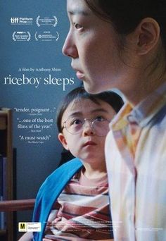 a woman and child are staring at each other in front of a book shelf with the words riceboy sleeps on it