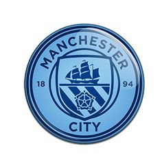 the manchester city logo is shown on a blue circle with white letters and an image of a ship