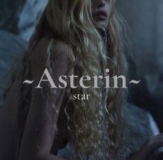 a woman with long blonde hair standing in front of a dark background and the words asterin star