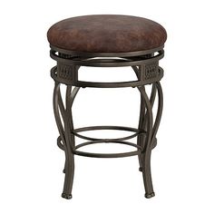 the backless stool is made from metal and has a brown leather cushion on it