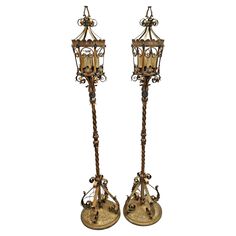 two antique style lamps are standing next to each other on a white background and one is turned upside down