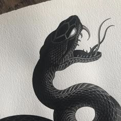 a black and white drawing of a snake