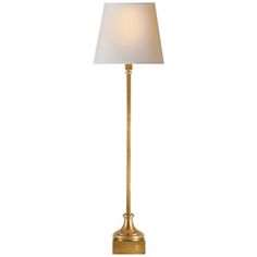 a gold lamp with a white shade on the base and a light bulb in the middle