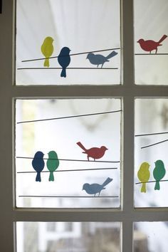 the window is decorated with birds on wires