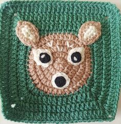 a crocheted square with a bear's head on the front and bottom