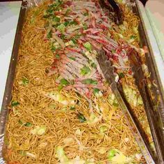 a large tray filled with noodles and meat