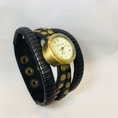 This Fun Watch Comes On A Wide Genuine Leather Cuff. This Is Just Under 2 Inches Wide At The Widest Point And Will Fit Up To An 8 1/2 Inch Wrist. This Is Adjustable. There Are Four Bands Of Leather With Fun Grommet Detail, And The Watch Is A Burnished Gold Tone. Just Pull The Small Plastic Tab(As Seen In Photo 3), Push The Watch Pin In, And The Watch Will Work. Only 2 Left, So Grab Yours. I Will Include Gift Box For You. Black Leather Watch Bands, Modern Black Leather Watch Band, Black Leather Cuff Watch Bands, Timeless Black Leather Strap Watch Bands, Black Leather Strap Watch Bands, Leather Cuffs, Wide Bands, Wrap Watch, Cool Watches