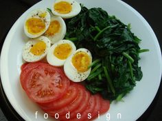 eggs, tomatoes and spinach on a plate with the words food design written below