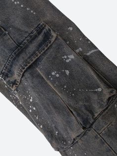 The Stained Cargo Jeans add a grunge-inspired touch with their distressed finish and splattered paint details. Featuring a relaxed, baggy fit, they pair perfectly with crop tops or casual tees for a laid-back streetwear look. Denim material Paint stained design Button & zip fastening Double pockets at front & back Cargo pockets Belt loop detail Low rise Wide leg Cotton, polyester Casual Paint Splatter Streetwear Bottoms, Urban Cotton Bottoms With Paint Splatter, Urban Style Cotton Bottoms With Paint Splatter, Urban Style Paint Splatter Cotton Bottoms, Casual Relaxed Fit Bottoms With Paint Splatter, Streetwear Washed Black Stonewashed Bottoms, Washed Black Stonewashed Bottoms For Streetwear, Stonewashed Black Bottoms For Streetwear, Distressed Washed Black Grunge Bottoms