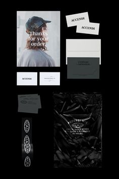 an assortment of black and white business cards, envelopes, and brochures