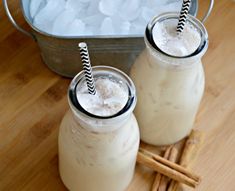 two mason jars filled with ice and cinnamon sticks