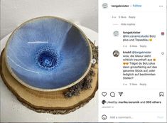 a blue bowl sitting on top of a wooden table next to a tweet