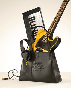 an electric guitar and headphones in a purse