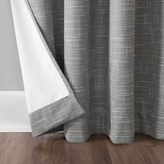 a close up view of a shower curtain with a white and gray checkered design