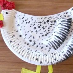 a paper plate that has a chicken on it and is decorated with black and white paint