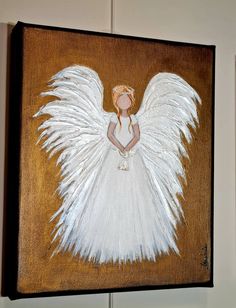 an angel painted on wood with white wings