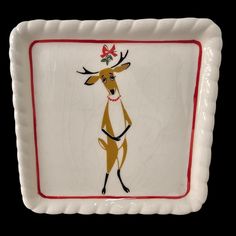 a white and red plate with a deer on it