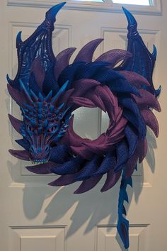 Perfect for the dragon lover! Wreath features blue and purple scales with matching wings, tail, and mask. Wreath measures approximately 26" in length. **If you are looking for something custom, just ask! I can work with you to make the perfect dragon. Fire can also be added for an additional fee.** Dragon Wreath, Hobby Room Design, Maple Shade, Wish Box, Dragon Fire, Purple Dragon, Dragon Lover, Hobby Room, A Dragon