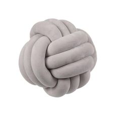 the knot pillow in grey is shown on a white background