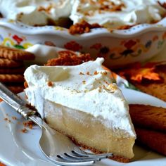 a piece of pie on a plate with a fork and crackers next to it