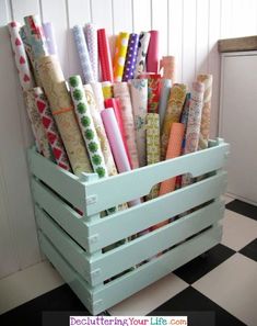 a wooden crate filled with lots of wrapping paper