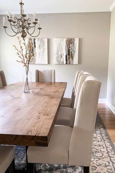 a dining room table with chairs and a chandelier