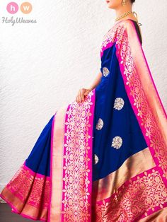 a woman in a blue and pink sari