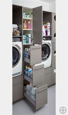 a washer and dryer in a room with shelves on the wall next to each other