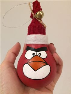 a hand holding an angry bird ornament