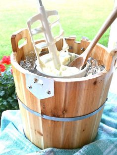 a wooden bucket filled with ice and an umbrella