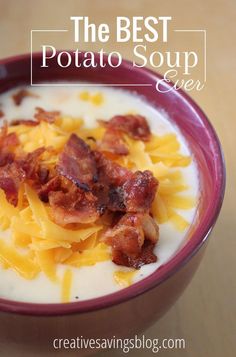 the best potato soup ever in a red bowl with bacon and cheese on top, sitting on a wooden table