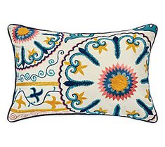 an embroidered pillow with blue and yellow designs on it