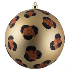 a gold ornament with black and orange designs on it