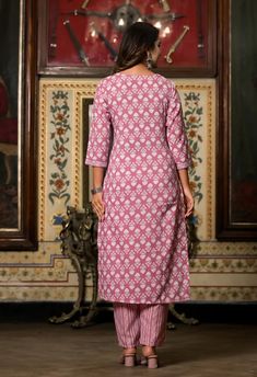 Grab this beautiful 3-piece set. The set comes with straight cut printed kurta has v neck, 3/4th sleeves & calf length teamed with printed trouser pants and a chanderi cotton dupatta to match. Color - Pink Kurta Fabric-Viscose Pant Fabric-Viscose Dupatta Fabric- Chanderi Cotton Neck-V Neck Sleeves-3/4th Sleeves Work - Print Detailing Washing Instructions-Dry Clean Model Height - 5.5 wearing size small. DISCLAIMER - The color of the product may be differ due to screen settings of device. A misprint here and a colour drop slip there is the beauty of printing which is not treated as a defect. Festive Printed Straight Kurta Pant Set, Festive Printed Pant Set With Straight Kurta, Cotton V-neck Sets For Diwali, Diwali Cotton V-neck Sets, Festive Fitted Sets With 3/4 Sleeve, Printed Straight Kurta Set For Eid, Navratri Printed Palazzo Set With Straight Kurta, Unstitched Printed Sets For Navratri, Traditional Printed Sets With Straight Kurta