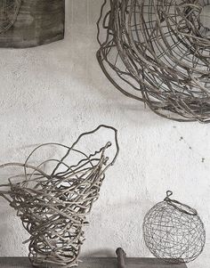 two wire baskets hanging on the wall