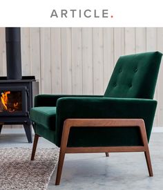 a green chair sitting in front of a wood burning stove on top of a rug