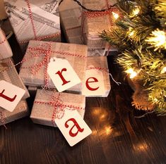 wrapped presents sitting on top of a table next to a christmas tree