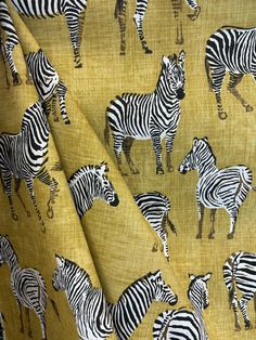 a group of zebras on a yellow background