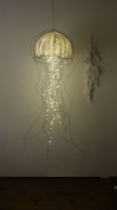 a light hanging from the ceiling next to a wall with a jellyfish on it