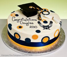 a graduation cake decorated with polka dots and a black cap on top that says congratulations douglas 2010